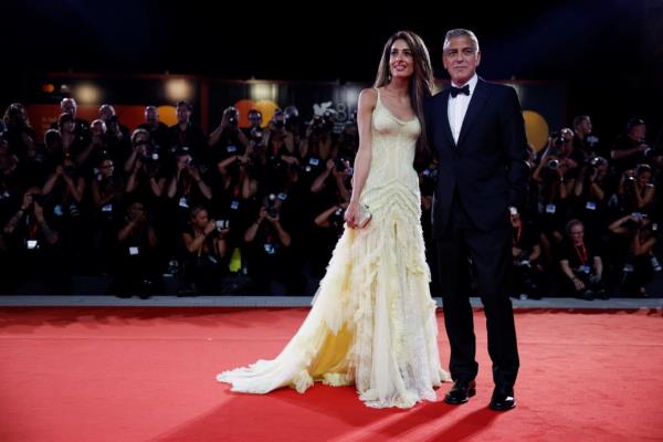 George and Amal Cloo<em></em>ney pose on the red carpet during the Venice Film Festival on September 1, 2024.