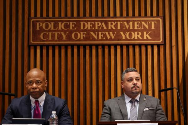 Mayor Eric Adams and Commissio<em></em>ner Edward Caban stare forward during a press conference.