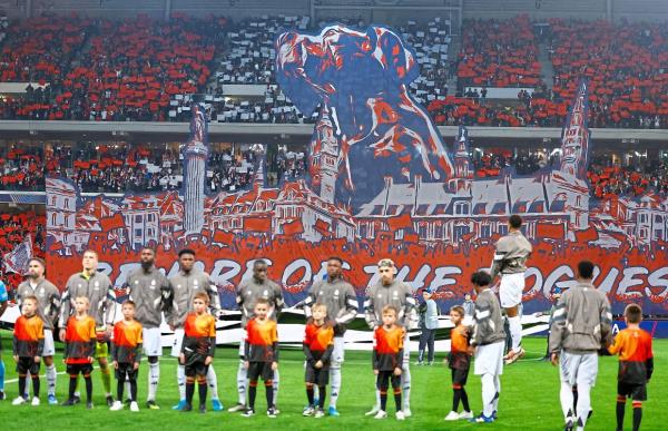 Real players stand behind Lille fans’ display of a tifo in the stands before the match. — Reuters