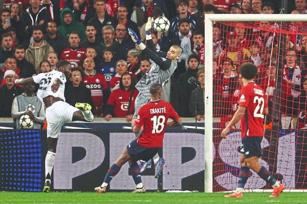 Lille’s Che<em></em>valier stops a header by Real’s German defender Anto<em></em>nio Ruediger. — AFP