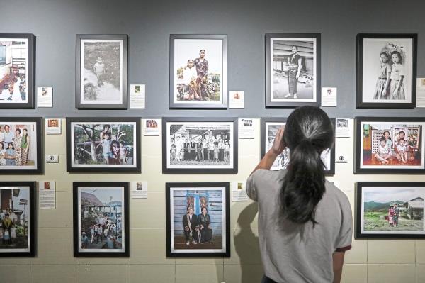 A visitor explores the 'Stories Behind Old Photographs' (Borneo Edition) exhibition at Charlie’s Cafe in KL last month. Photo: The Star/Yap Chee Hong 