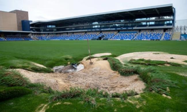 Damage to the pitch following flooding at Cherry Red Records Stadium.