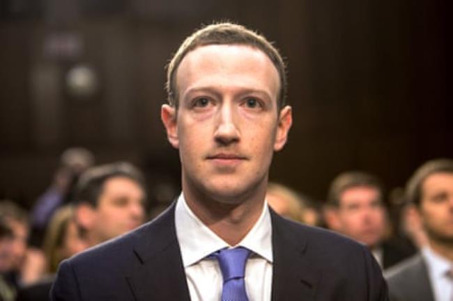 Mark Zuckerberg, wearing a suit and tie and a neutral ex<em></em>pression, looks ahead