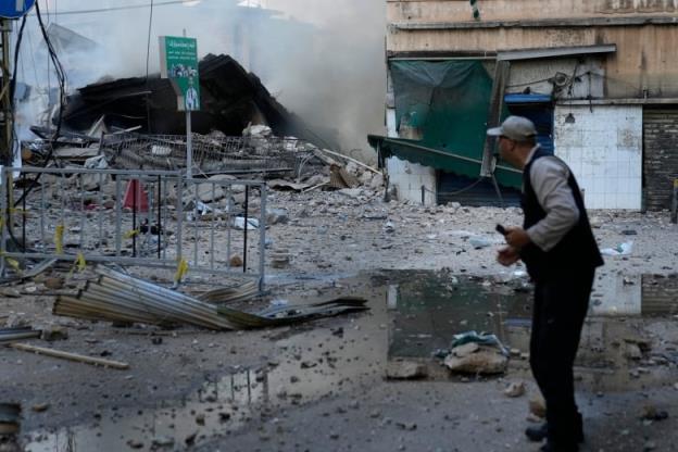 Man looks at rubble