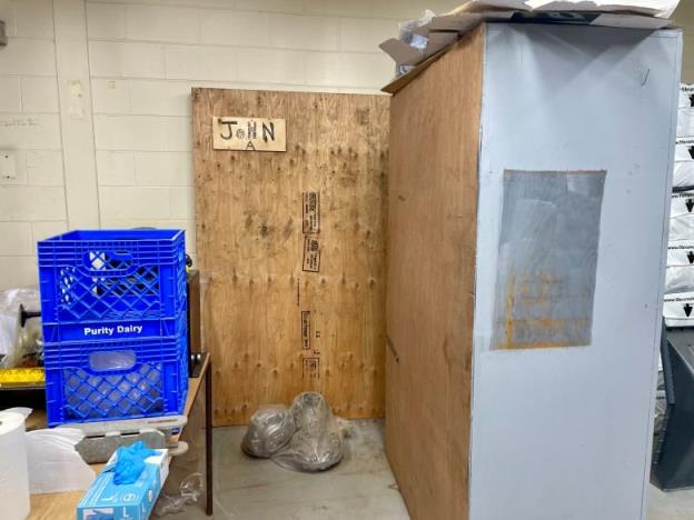 A plyboard box covers a portrait of John A Macdo<em></em>nald in a storage room.