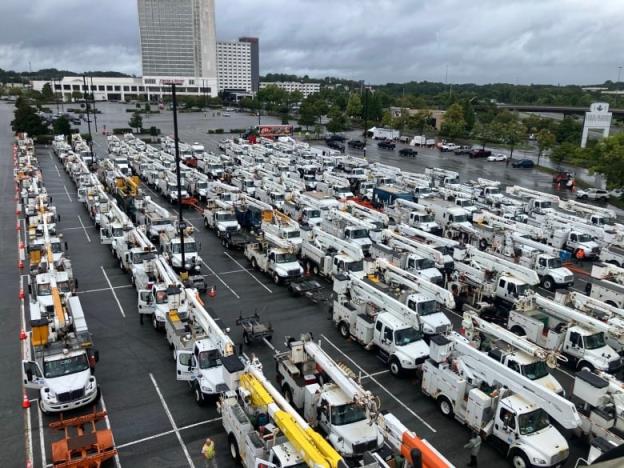 Dozens of heavy trucks with lifts in a parking lot