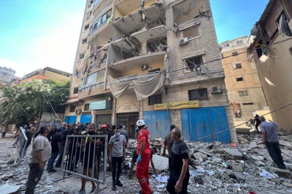 Rescuers arrive at the scene of an Israeli airstrike in Beirut's suburb of Ghobeiri,