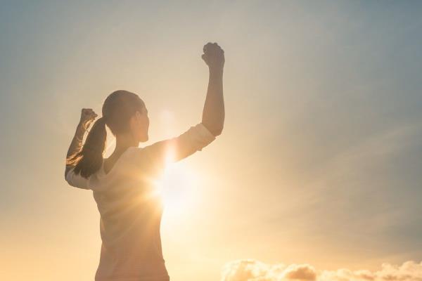 woman looking triumphant in the sunshine