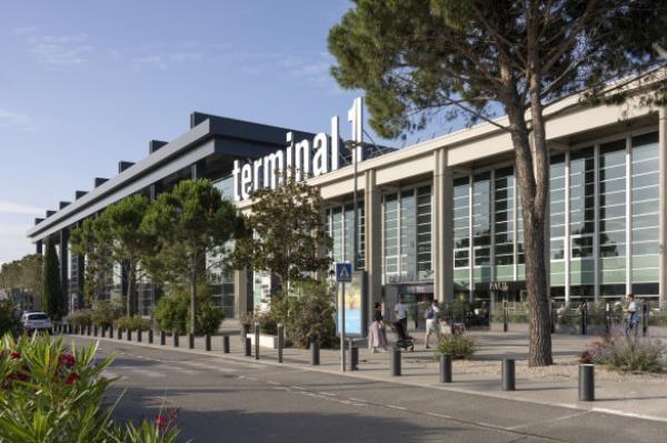 The exterior of Marseille Airport is softened with greenery.