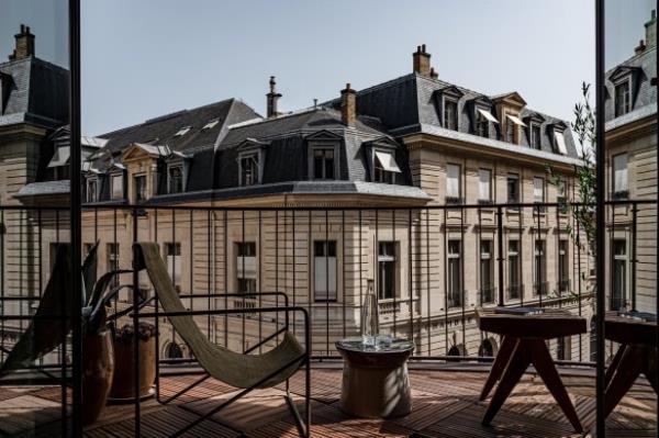 Balcony views dominated by stately Haussman-style buildings.