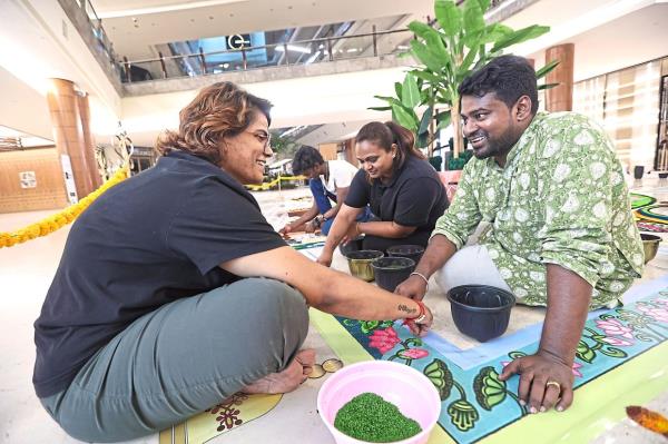 By teaching the art of kolam-making, Ruben not o<em></em>nly preserves tradition but also empowers women like Meenatchy (left) to earn an income. Photo: The Star/Azman Ghani