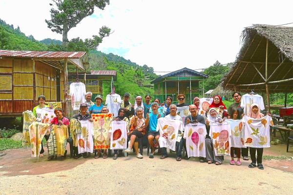 The writer (standing third from left) and her group showing off their naturally-dyed T-shirts and cloths.
