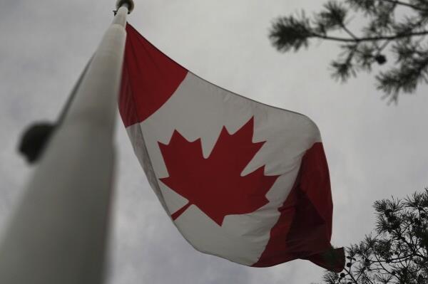 The Canadian flag is blown by wind on Centre Island in Toro<em></em>nto on Thursday, Sept. 19, 2024. (AP Photo/Angie Wang)