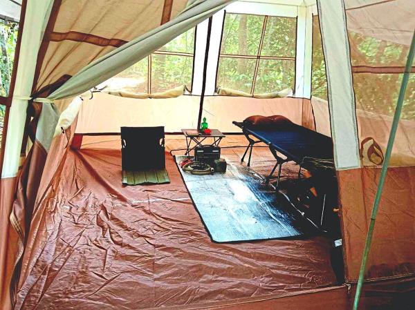 With a small Buddha statue gracing a collapsible table, Chan’s roomy tent, designed to accommodate four to six people, affords him relative luxury when he camps solo.