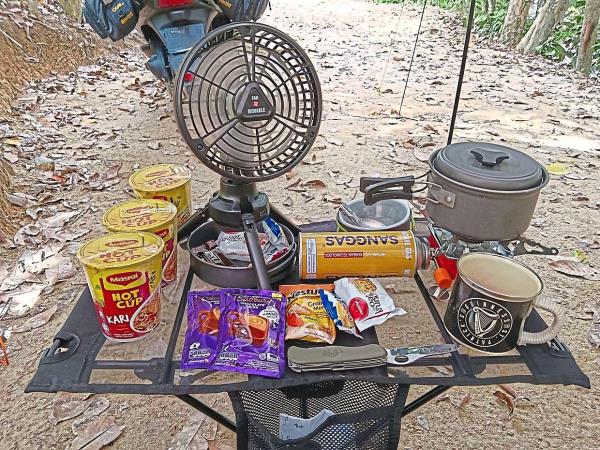 Chan laying out his ration of instant noodles and snacks, which serve as quick and co<em></em>nvenient options when hunger pangs suddenly strike.