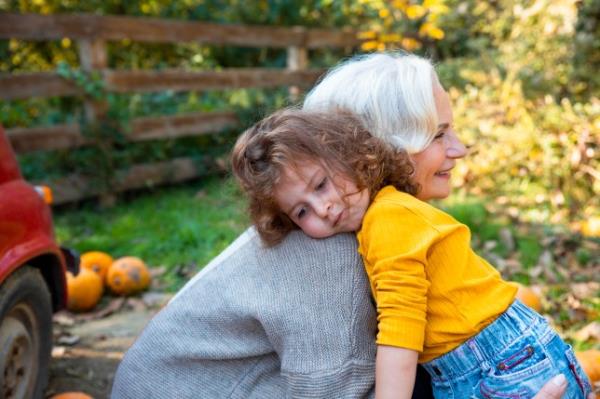 Comforting hugs of little girl and her grandmother