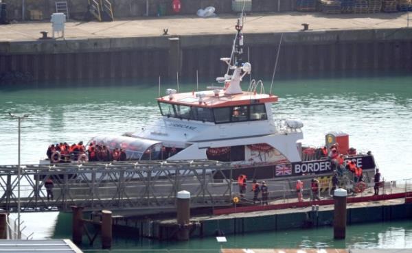 A group of people thought to be migrants are brought in to Dover, Kent, 