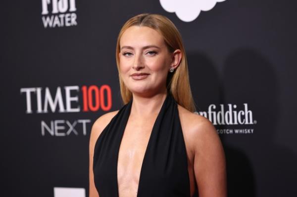 Amelia Dimoldenberg at a red carpet event wearing a black halter-neck dress