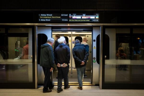 Passengers getting on board Elizabeth line train in London. 