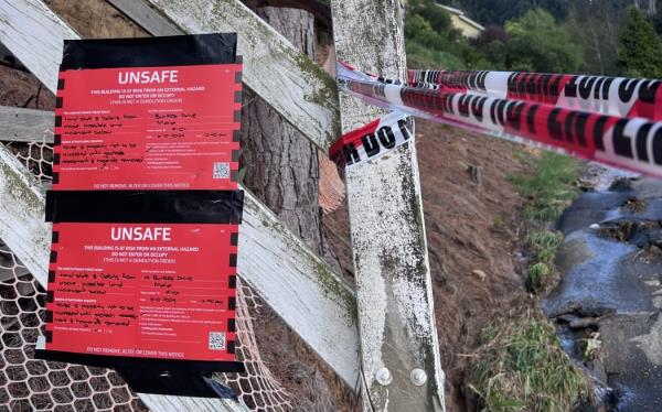 A red sticker at the boundary of a Dunedin property on 7 October after massive downpours caused floods, landslides and road closures.