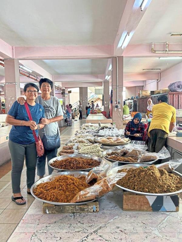 The writer (right) and Kulwant at the Siti Khadijah Market.