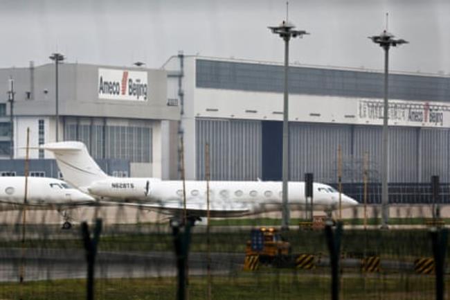 A white jet at an airport