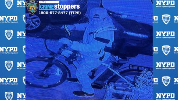 Photo shows a man on a bicycle.