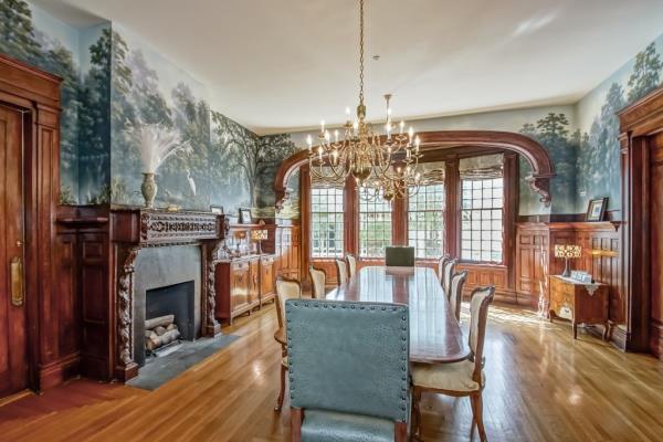 Dining room inside the 1711 Palmer Avenue mansion in New Orleans, featuring a chandelier and a fireplace; former property of James Carville