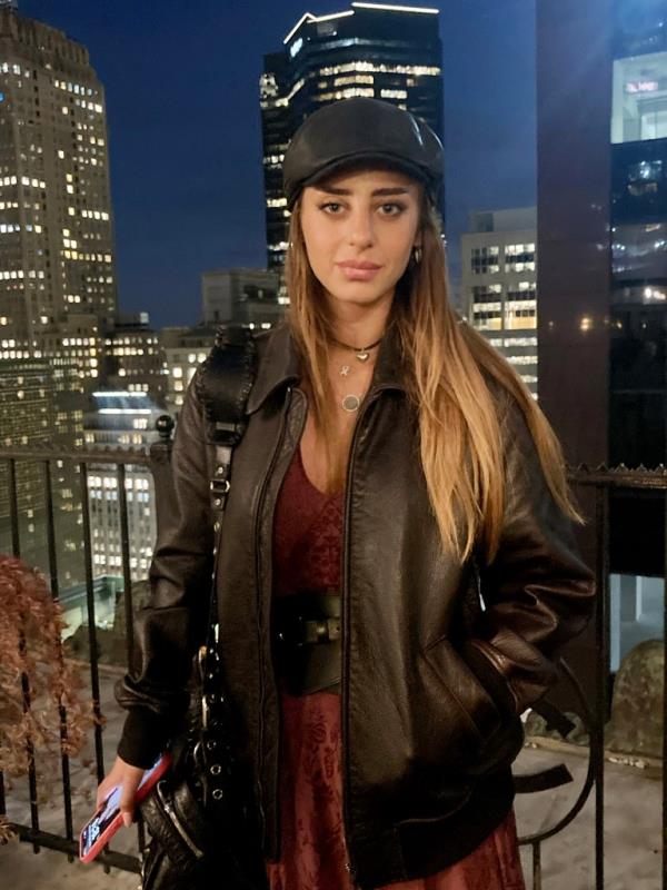 Mia Schem looking at the camera wearing a dark hat and dark jacket