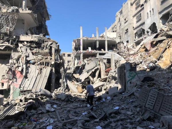 Palestinians inspect a destroyed home in the Gaza Strip.