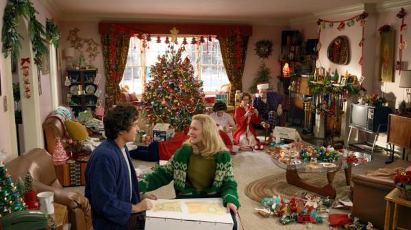 Tom Hanks and Robin Wright posing for a photo in 2024, with a Christmas tree in the background