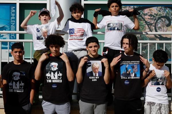 Young people wear t-shirts with the image of Republican presidential candidate, former President Do<em></em>nald Trump.