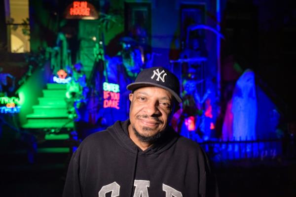 Michael Spruill in front of the Halloween decorations at his home at 143 St. James Place. 
