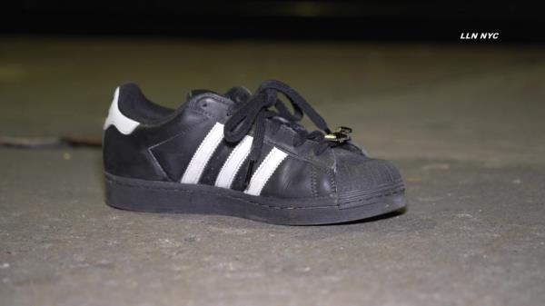 Blood splattered on the sidewalk and empty sneakers marked the chilling scene in the aftermath.