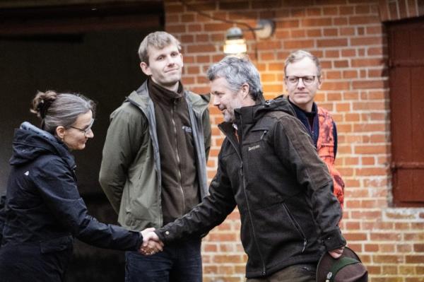 King Frederik shaking hands with a group of people during a Royal Hunt at Gludsted Plantation in Denmark