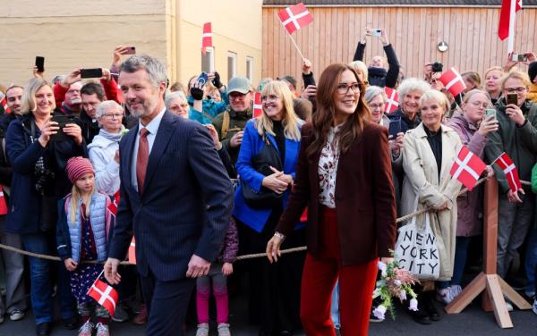 King Frederik X and Queen Mary of Denmark waving goodbye to crowd in Flensburg, Germany during their 20th wedding anniversary celebration.