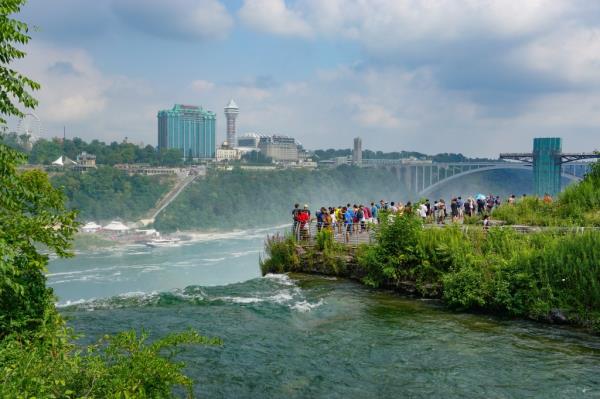 Tourists on Luna Island enjoy the view of the Niagara Gorge through the mist.