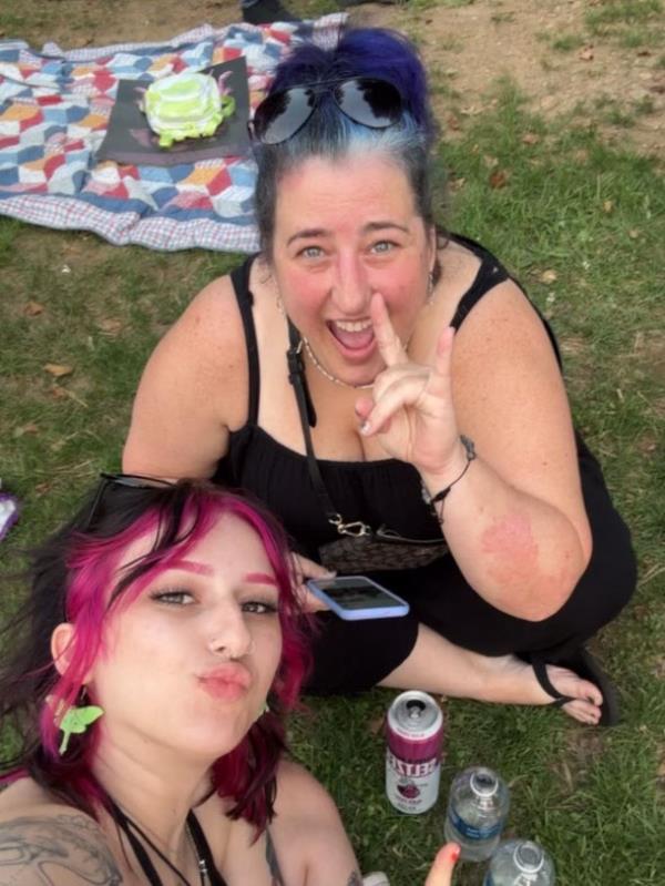 Kass Adams and her mom, Jennifer Fishburn, sitting on the grass