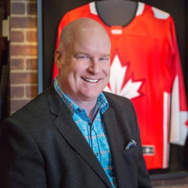 Scott Moore, CEO of Invictus Games, smiling in a red shirt
