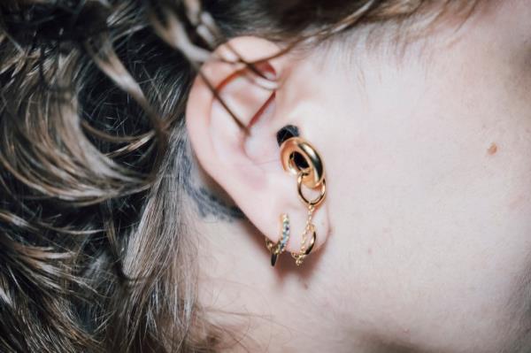 Close up of Row Kiefer wearing earplug earrings at The Bush Bar, Brooklyn, captured by photographer Stefano Giovannini