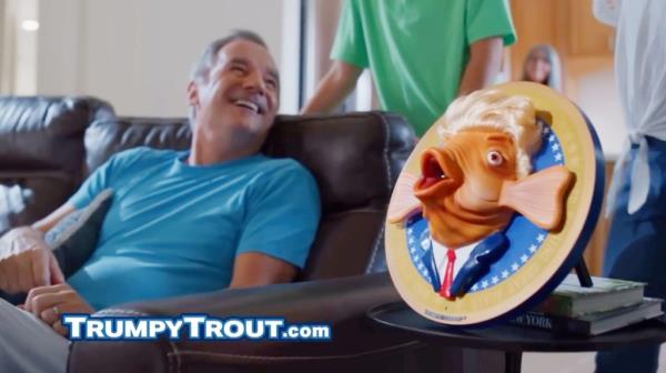Man sitting on a couch with a fish head on a table, screenshots from Trump Trout commercial