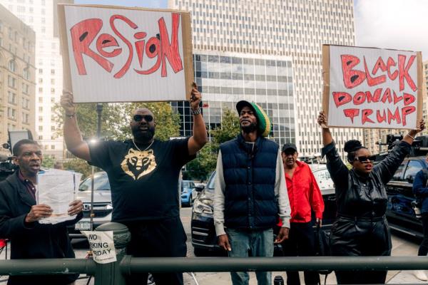 Demo<em></em>nstrators holding protest signs outside Manhattan federal court during NYC Mayor Eric Adams' pretrial co<em></em>nference in corruption case