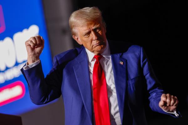 Former U.S. President Do<em></em>nald Trump dancing on stage at a campaign rally in Novi, Michigan on October 26, 2024.