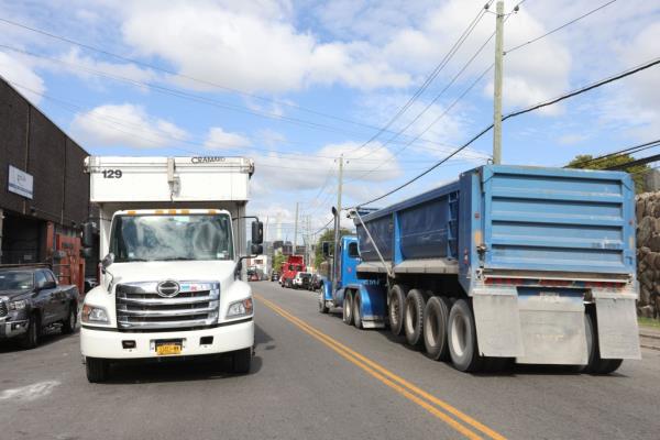 A busy street on Review Avenue, Long Island City, Queens, NY with trucks denoting heavy traffic and potential location for a co<em></em>ntentious bike lane