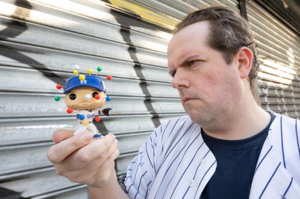 Mike L stares down the Freddie Freeman doll.