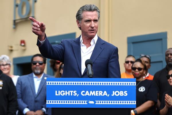 Gov. Gavin Newsom speaking at podium that says 