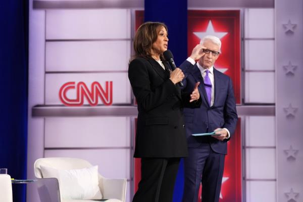 CNN moderator Anderson Cooper looks on as Harris answers a question during the town hall.