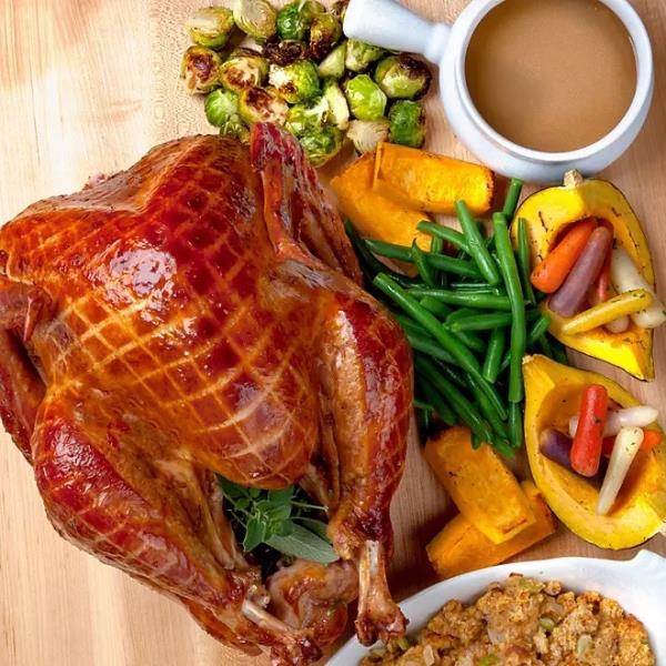 Thanksgiving meal including turkey, stuffing and brussels sprouts.