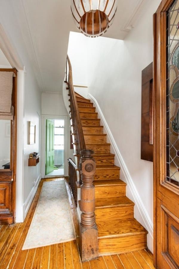 A mahogany staircase co<em></em>nnects the levels.