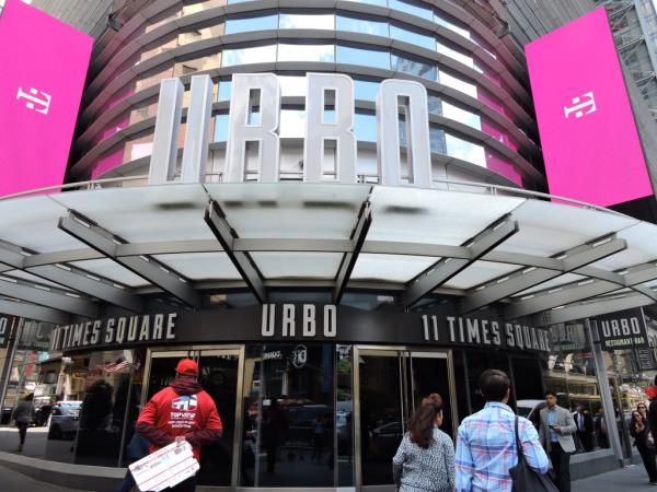 A group of people walking in front of 11 Times Square building, leased by London-ba<em></em>sed Path Entertainment